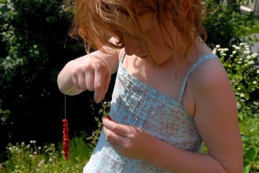 girl making the strawberry string. Please note: No negative use allowed.