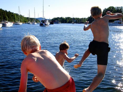 boys jumping into the sea. Please note: No negative use allowed.
