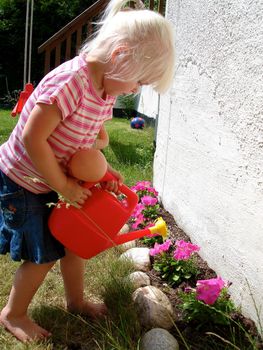 girl watering the flowers. Please note: No negative use allowed.