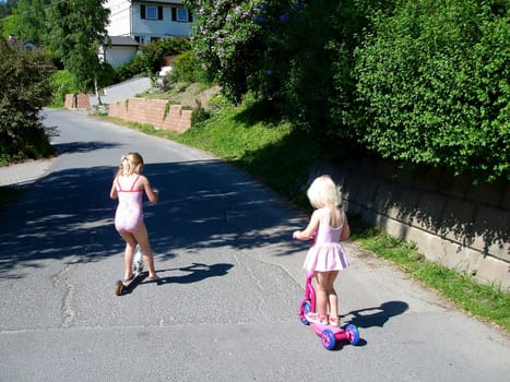 girls playing Scooter. Please note: No negative use allowed.