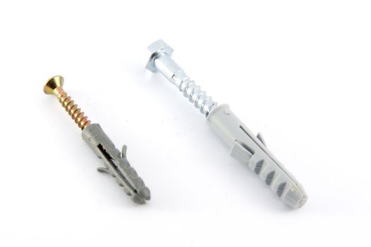 Screws with plastic dowels, closeup view, isolated on white 