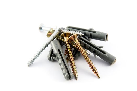 Screws with plastic dowels, closeup view, isolated on white 
