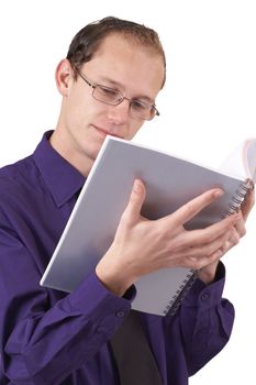 Young successful businessman wearing office clothes reading a book. Isolated on white background