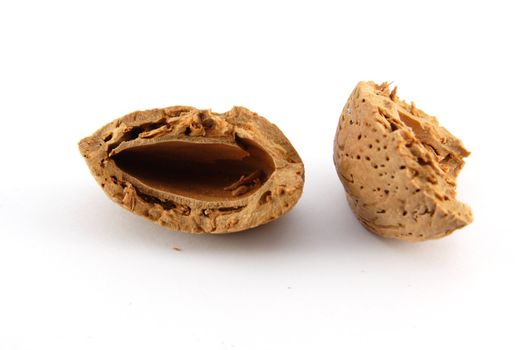 Cracked almond shell on white background