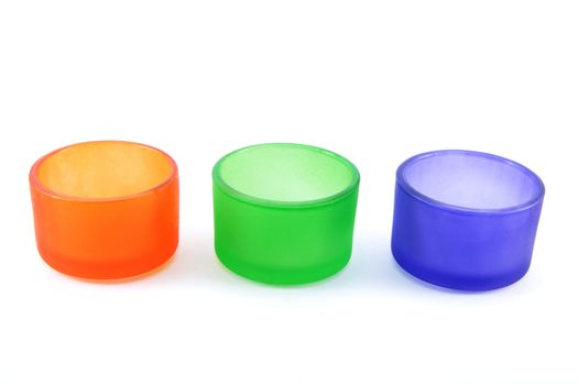 Colored candle holders on white background 
