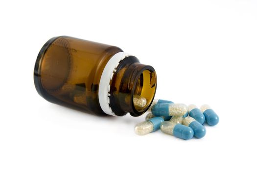 Pills from bottle on the white 
