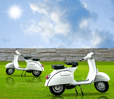 Retro white motorbike in the garden with nice sky