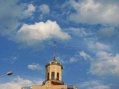 The house with a tower over the cloudy sky