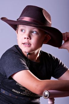 Young boy. Portrait in studio on a grey background.