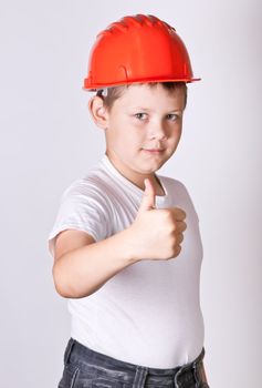 Portrait of a boy in a red protective helmet