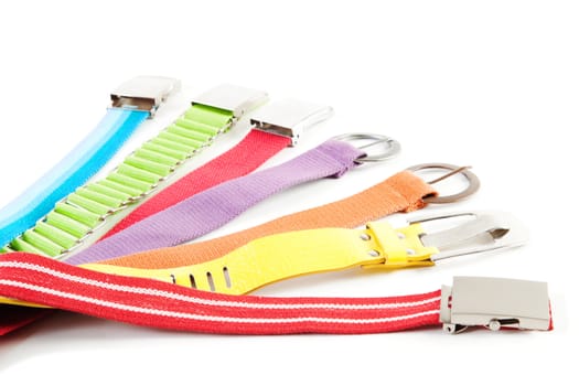 7 rainbow colored textile belts isolated over white background