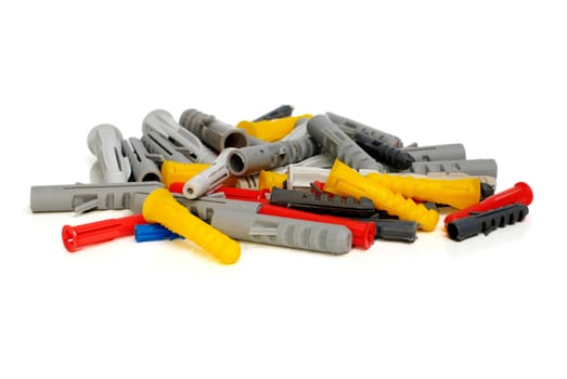 Blue, red, yellow and white plastic dowels on a white background.