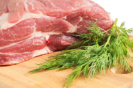 Piece of pork for roasting on a wooden board. Isolated on white.