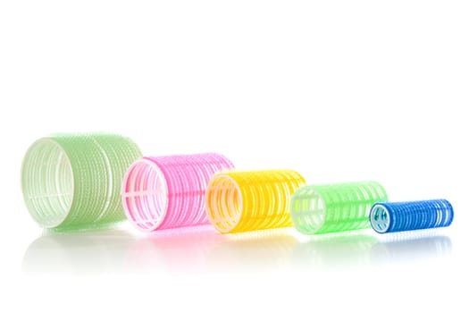 Multicolored hair curlers isolated over white background