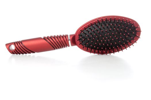 Red hairbrush isolated over white background
