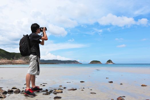 Photographer taking photo on beach