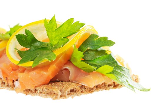 Sandwich snack - salmon with lemon on rye bread. Isolated on white.