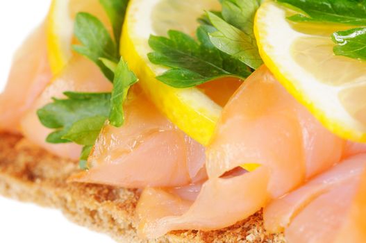 Sandwich snack - salmon with lemon on rye bread. Isolated on white.