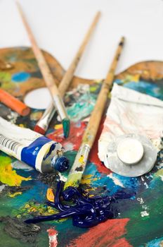 artist's palette with colorful paint and brushes.