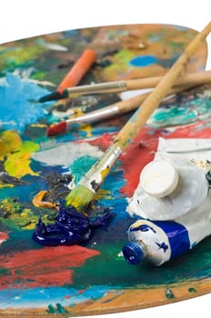 artist's palette with colorful paint and brushes.