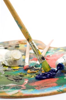 artist's palette with colorful paint and brushes.