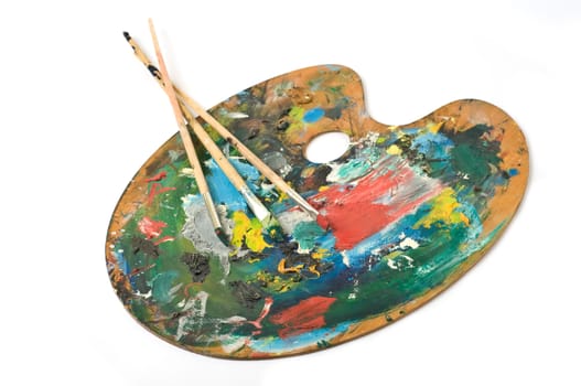 artist's palette with colorful paint and brushes.