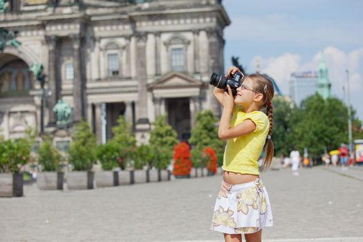 young girl with photo camera on Cathedral in Berlin background