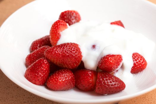 Sliced fresh strawberries with cream yoghurt