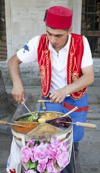 June 2011 Turkish ice cream vendor in typical uniform outside Topkapi Palace, Istanbul Turkey. Portrait