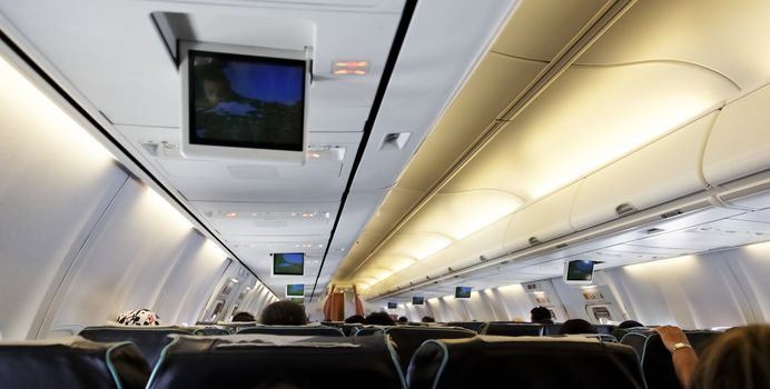 June 2011, inside of a passenger airline, backs of passengers, somewhere over Asia Indian Ocean