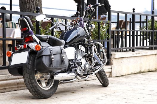 June 2011 Black cruiser motorcycle parked outside a restaurant Istanbul Turkey