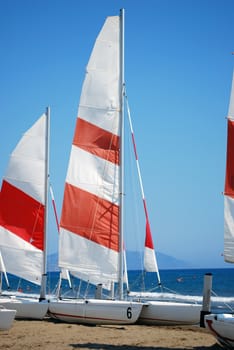 Empty Sailboats Standing on the Beach Sand at the Sea