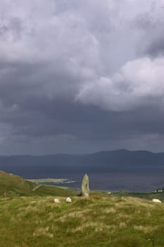 an ancient stone marker on a hill on bear island on the west coast of ireland