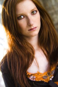 Studio portrait of a natural redhead in sunlight