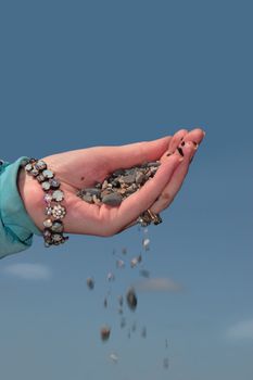 a hand full of earth against a beautiful blue sky