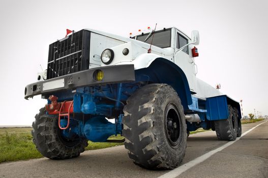 white powerful airport auxiliary tractor awaiting orders