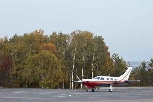 singel small private aircraft standing on airfield