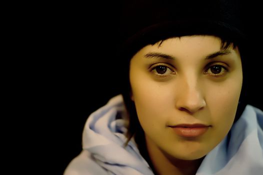 young casual woman portrait in a black background