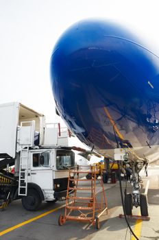 jet airplane is being checked and serviced before the flight