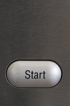A start button on a textured grey background. Space for text on the background.