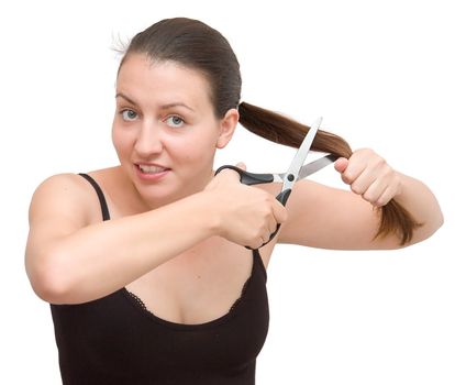 The young woman cuts off the hair on a white background