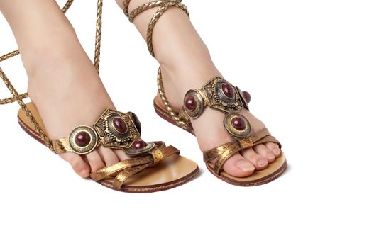 rich decorated sandals weared on the beautiful female feet