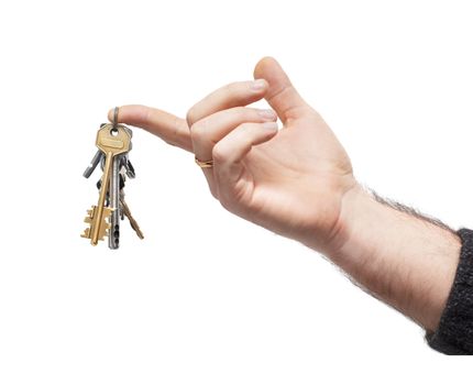 man's hand holds bunch of keys, hanging on keyring. isolated on white
