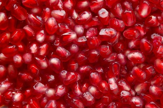 red ripe pomegranate seeds natural background