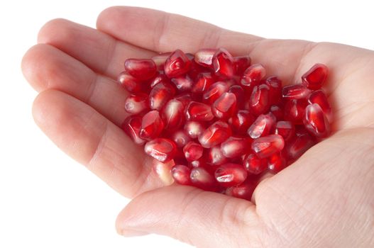 red ripe pomegranate seeds on the human palm