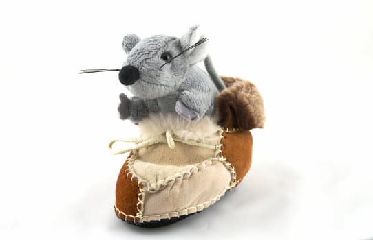The grey toy mouse sitting in a boot
