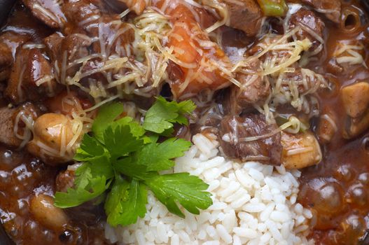 closeup of boiling goulash with mushrooms and rice