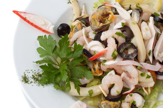 prepared shrimp and mussel salad with olives, lemon and parsley