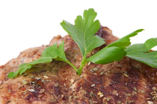 closeup of grilled beef steak with parsley on top, isolated, selective focus