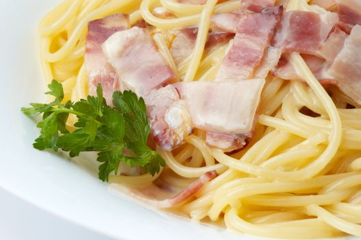 closeup of just boiled spaghetti with bacon sauce